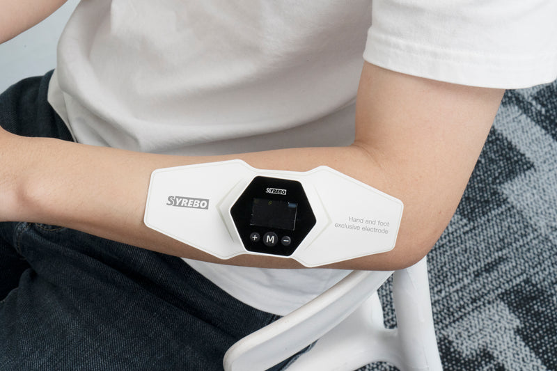 Low and medium frequency electrotherapy system applied on the arm for targeted muscle treatment.