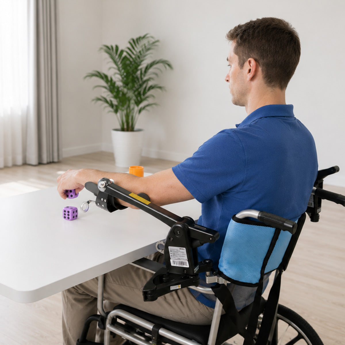 Syrebo Dynamic Arm Support mounted on a wheelchair for upper-limb task-oriented training